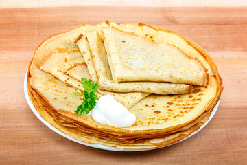 Pancakes with sour cream in a bowl