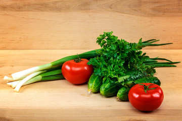 Fresh vegetables on the a wooden background.