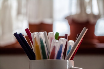 Different colored pencils in a cup