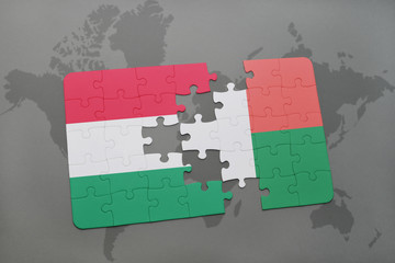 puzzle with the national flag of hungary and madagascar on a world map