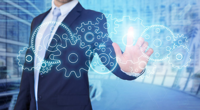 Businessman touching technology interface with gear wheel settin