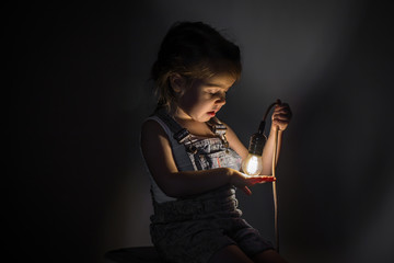 little cute girl with light bulb in hand