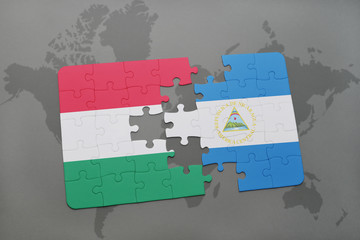 puzzle with the national flag of hungary and nicaragua on a world map