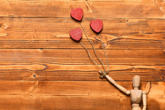 gestalta or poppet toy holding hearts