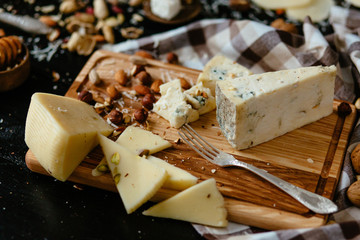 Cheeseboard.  Delicious blue cheese on the board. Blue cheese Gorgonzola with nuts
