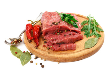 Meat on a cutting board and spices on white background.