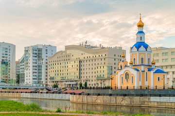 Fototapeta na wymiar Church of the Archangel Gabriel, Belgorod State University dormitory on embankment of river Vezelka