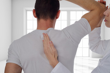 Chiropractic, osteopathy, dorsal manipulation. Therapist doing healing treatment on man's back ....