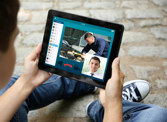 Man video conferencing on tablet. Online car service concept.