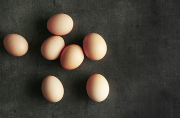 Raw eggs on color background