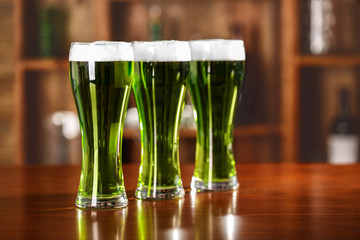 St. Patrick Day concept. Glasses of green beer on bar counter