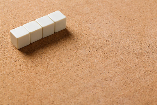 Blank cubes on cork board