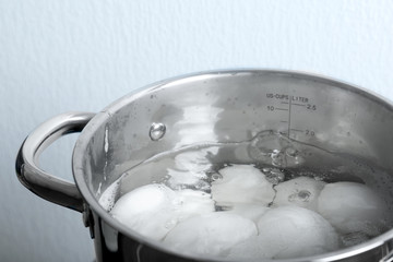 Fototapeta na wymiar Eggs boiling in pan, closeup