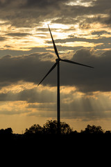 Fototapeta na wymiar wind turbine power generator at sunset