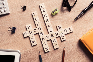Conceptual business keywords on table with elements of game making crossword
