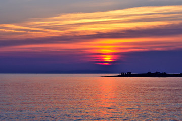 Naklejka na ściany i meble Beautiful Aegean Sea sunset with vibrant clouds. Greek travel destinations poster..