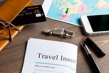 concept booking travel insurance on wooden background