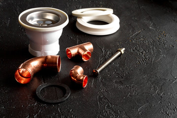 concept plumbing tools on dark background