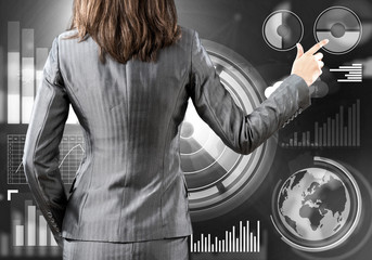 Fototapeta premium Businesswoman standing with back and pressing icon on media screen