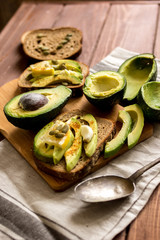 making sandwiches with avocado healthy organic food top view