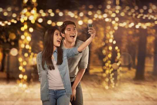 Happy Asian Couple In Love Taking Selfie Photo