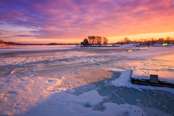 View of a frozen lake during sunrise in winter season.
Location: Ramsey Lake, Ontario, Canada