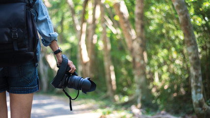 Travele woman hand holding camera