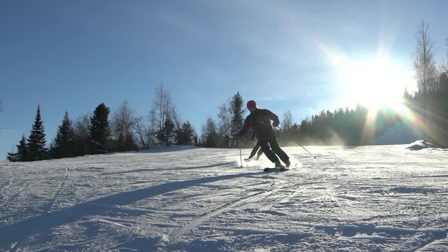 Skier skiing slope on sunny winter day