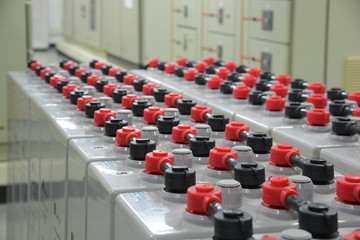 Room with many cables and many batteries.