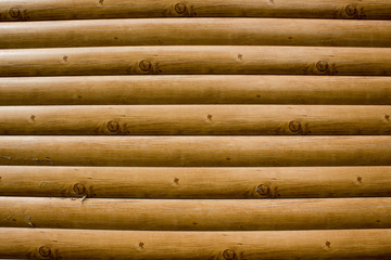 A wall of logs as background