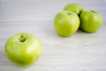 Three green apples on the table