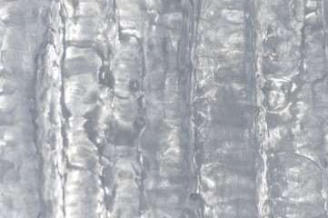 Ice background with icicles completely joined together