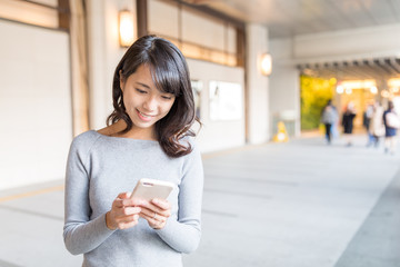 Woman using cellphone to text message