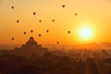Beautiful sunrise and hot air balloons over ancient pagoda in Ba
