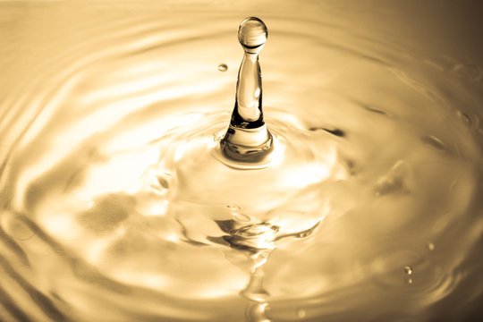 Beautiful Drops of liquid gold and ripple ,abstract background
