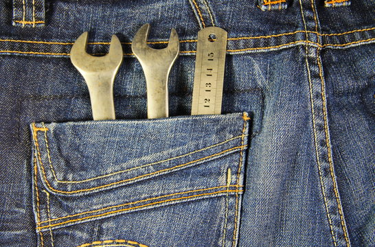 Wrench tools and ruler in the pocket jeans