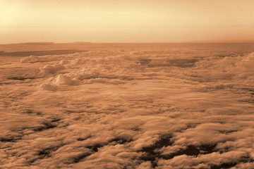 Above the clouds. Photo from the plane. Black & White (coffee with milk) toning.