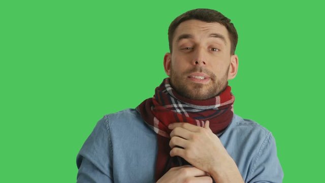 Mid Closeup Shot of a Sick Man in Scarf Caughing and Sneezing. Background is Green Screen. Shot on RED Cinema Camera 4K (UHD).