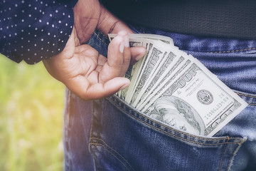 Bankroll dollar in the jeans pocket.