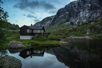 Fototapeta na wymiar house in Norwegian lake and dramatic sky