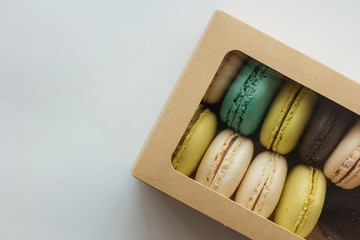 Multicolored macarons in box top view