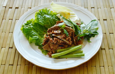 spicy chop pork and liver salad eat couple with fresh vegetable on plate
