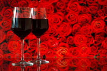 Two glasses of red wine against bokeh background with sparkles a