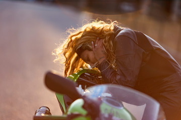 woman setting up her motorcycle to run