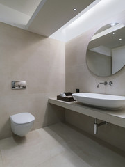 interior view of a modern bathroom coated on marble in foreground the countertop