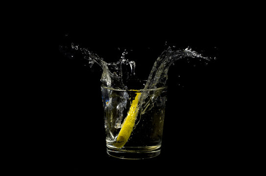lemon splashing in glass