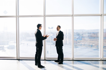 Two businessmen dicussing business perspectives in office