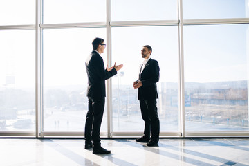 Two businessmen dicussing business perspectives in office