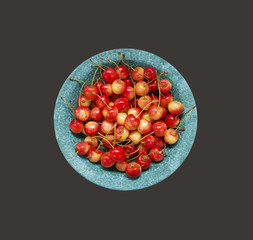 Cherry fruit. Sweet cherries in blue ceramic bowl. Top view. Ripe and tasty cherries on a wooden background.