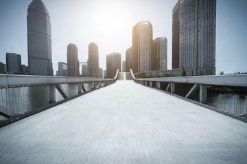 Empty bridge with modern city background.